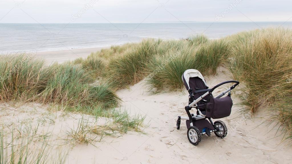 Baby stroller standing at a beach 