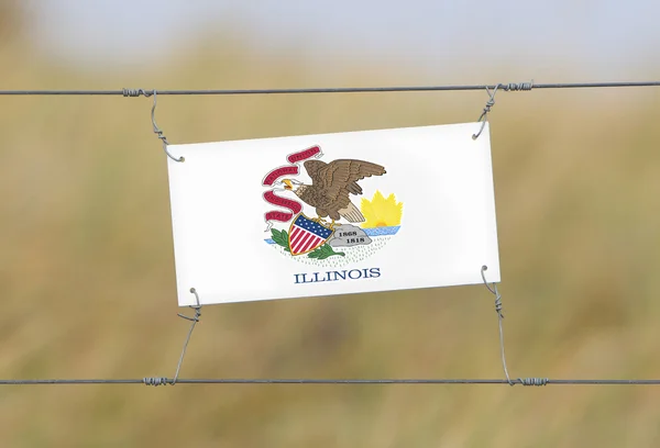 Border fence - Old plastic sign with a flag — Stock Photo, Image