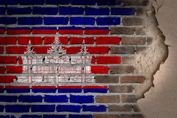 Parede de tijolo escuro com gesso Camboja — Fotografia de Stock