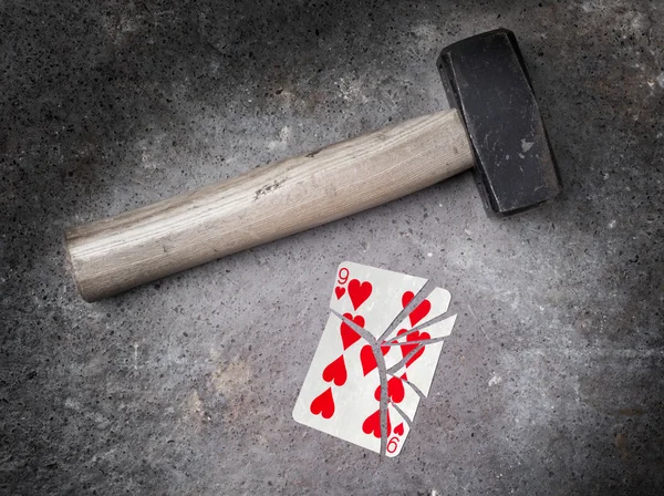 Hammer with a broken card, nine of hearts — Stock Photo, Image