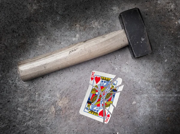 Hammer with a broken card, king of hearts — Stock Photo, Image