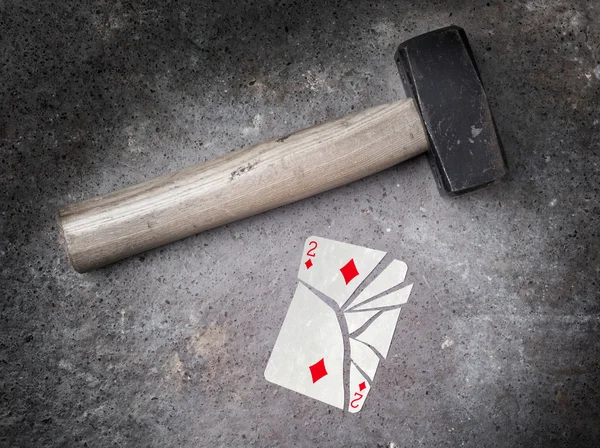 Hammer with a broken card, two of diamonds — Stock Photo, Image