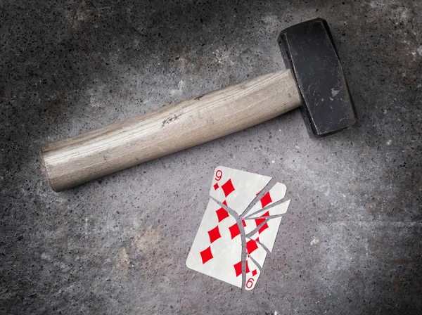 Hammer with a broken card, nine of diamonds — Stock Photo, Image