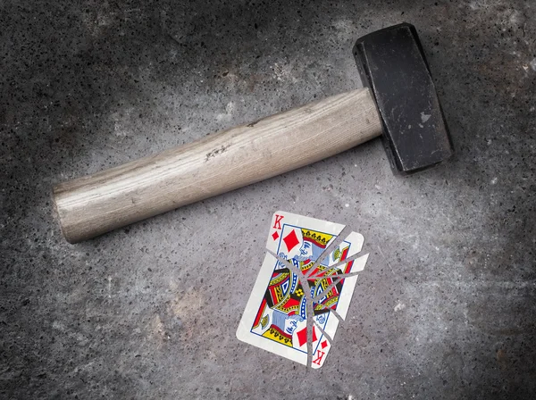 Hammer with a broken card, king of diamonds — Stock Photo, Image