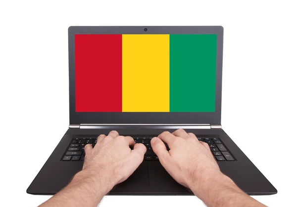 Hands working on laptop, Guinea — Stock Photo, Image