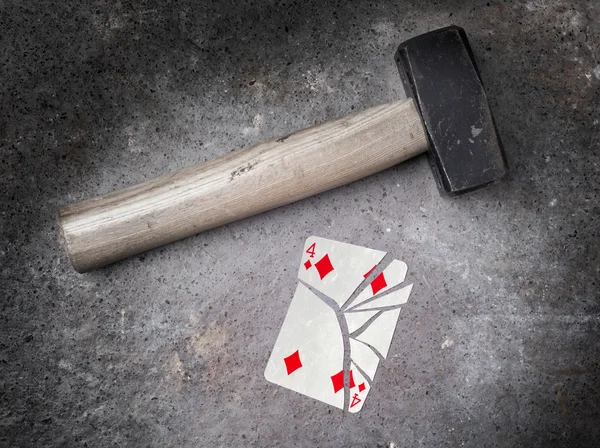 Hammer with a broken card, four of diamonds — Stock Photo, Image