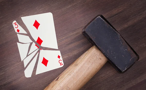 Hammer with a broken card, three of diamonds — Stock Photo, Image