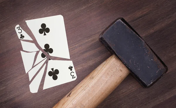 Hammer with a broken card, three of clubs — Stock Photo, Image