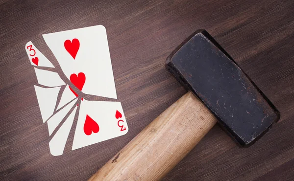 Hammer with a broken card, three of hearts — Stock Photo, Image