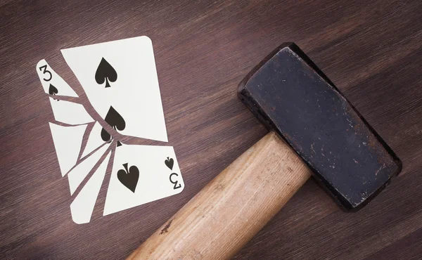 Hammer with a broken card, three of spades — Stock Photo, Image