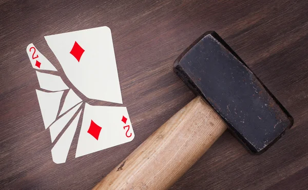 Hammer with a broken card, two of diamonds — Stock Photo, Image