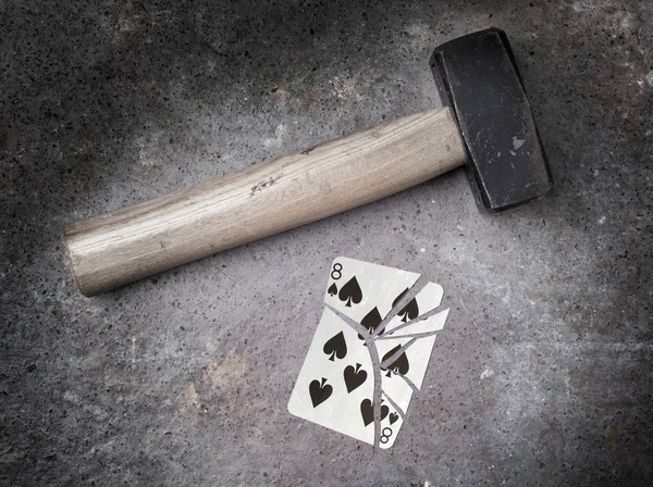 Hammer with a broken card, eight of spades — Stock Photo, Image