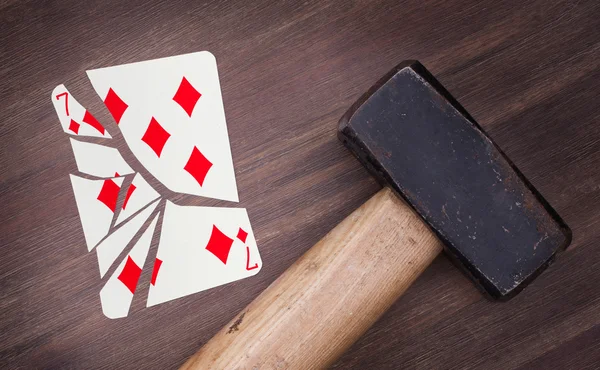 Hammer with a broken card, seven of diamonds — Stock Photo, Image