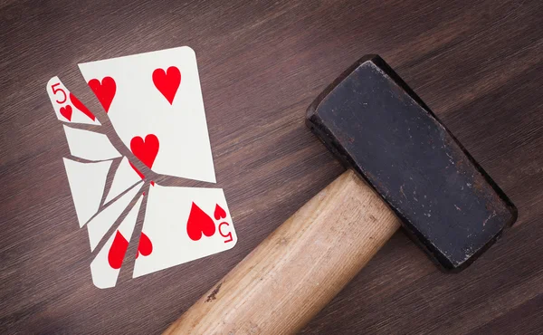 Hammer with a broken card, five of hearts — Stock Photo, Image