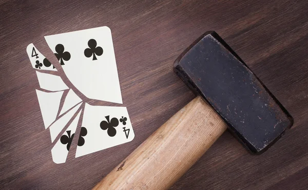 Hammer with a broken card, four of clubs — Stock Photo, Image