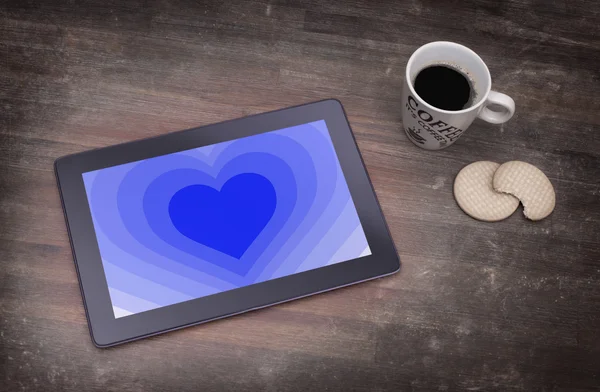 Heart shape backgound on tablet — Stock Photo, Image