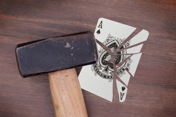 Hammer with a broken card, ace of spades — Stock Photo, Image