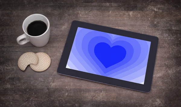 Heart shape backgound on tablet — Stock Photo, Image