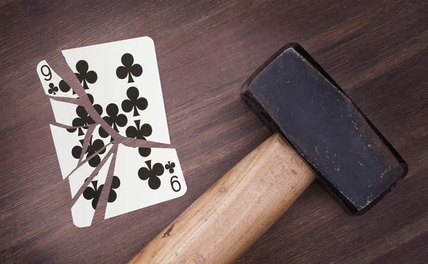 Hammer with a broken card, nine of clubs — Stock Photo, Image