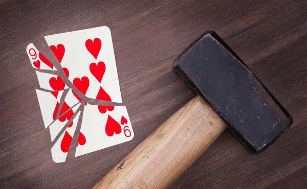 Hammer with a broken card, nine of hearts — Stock Photo, Image