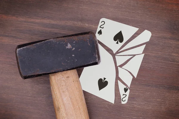 Hammer with a broken card, two of spades — Stock Photo, Image