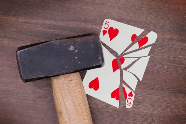 Hammer with a broken card, five of hearts — Stock Photo, Image