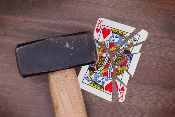 Hammer with a broken card, king of hearts — Stock Photo, Image