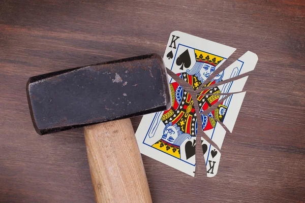 Hammer with a broken card, king of spades — Stock Photo, Image