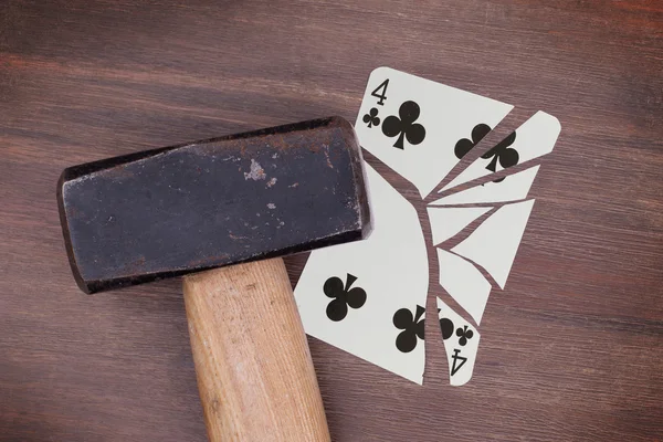 Hammer with a broken card, four of clubs — Stock Photo, Image