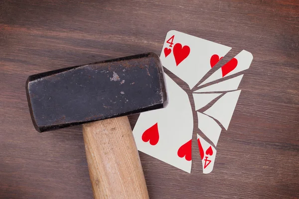 Hammer with a broken card, four of hearts — Stock Photo, Image