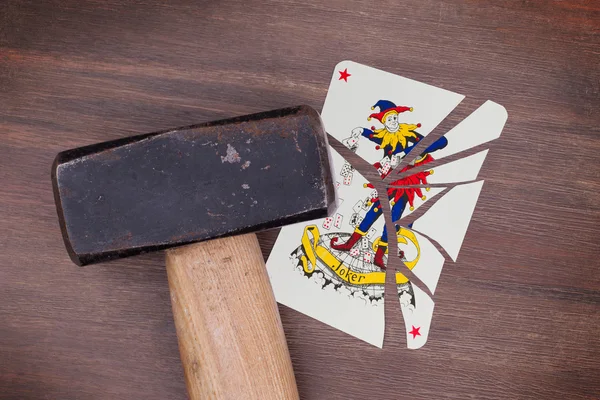 Hammer with a broken card, joker — Stock Photo, Image