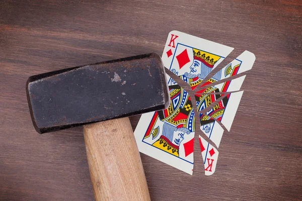 Hammer with a broken card, king of diamonds — Stock Photo, Image