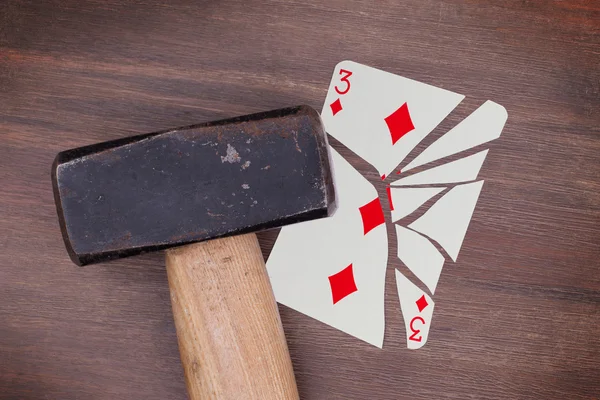 Hammer with a broken card, three of diamonds — Stock Photo, Image