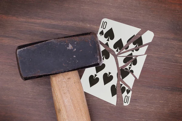 Hammer with a broken card, ten of spades — Stock Photo, Image