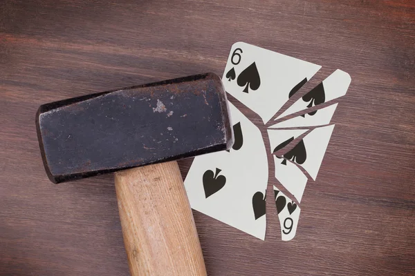 Hammer with a broken card, six of spades — Stock Photo, Image