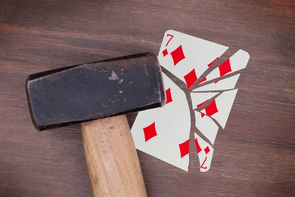 Hammer with a broken card, seven of diamonds — Stock Photo, Image