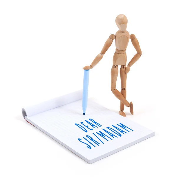 Wooden mannequin writing in scrapbook - Dear sir madam — Stock Photo, Image