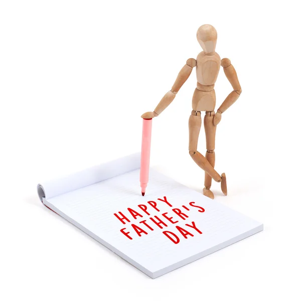 Wooden mannequin writing in scrapbook - Happy fathers day — Stock Photo, Image