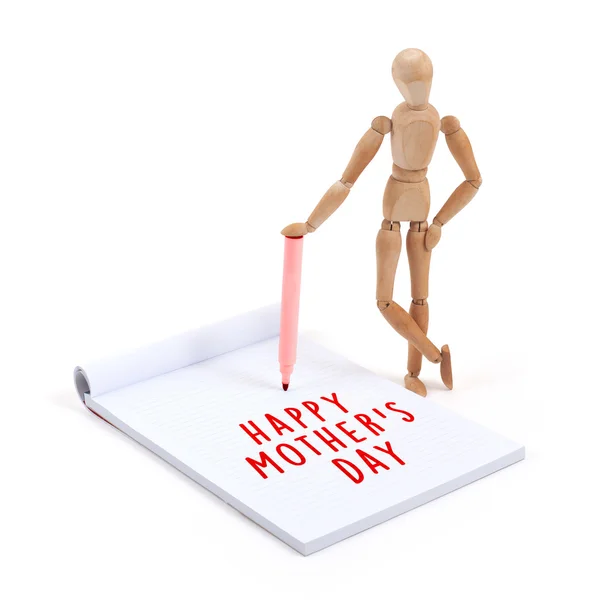 Wooden mannequin writing in scrapbook - Happy mothers day — Stock Photo, Image