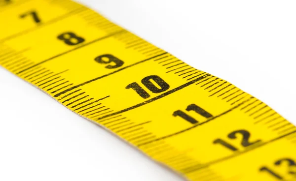 Yellow measuring tape isolated - selective focus — Stock Photo, Image