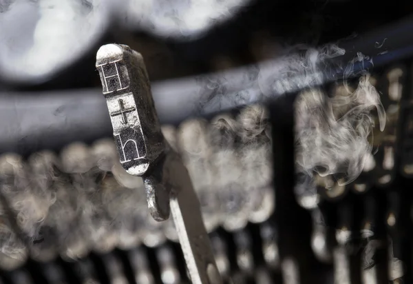 H hammer - old manual typewriter - mystery smoke — Stock fotografie