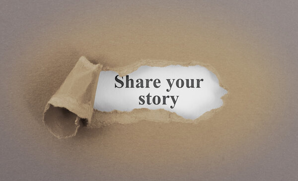 Text appearing behind torn brown envelop