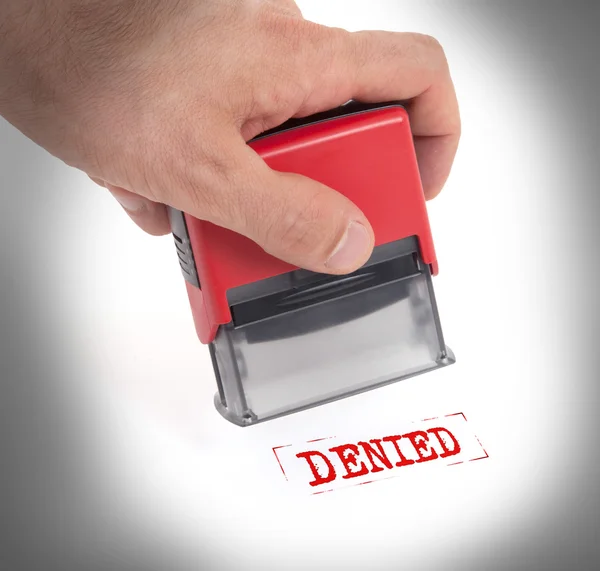 Plastic stamp in hand, isolated — Stock Photo, Image