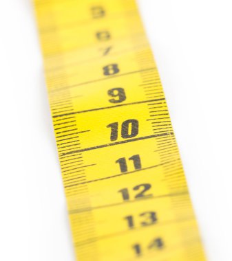 Yellow measuring tape isolated - selective focus