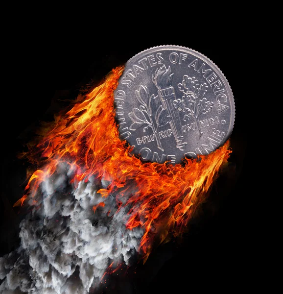 Burning coin with a trail of fire and smoke Royalty Free Stock Photos