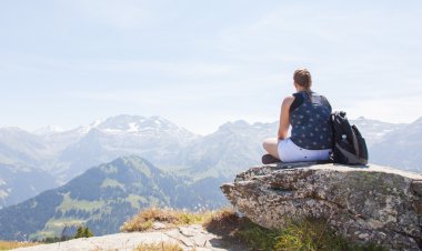 Hiker, young woman with backpack enjoying a view