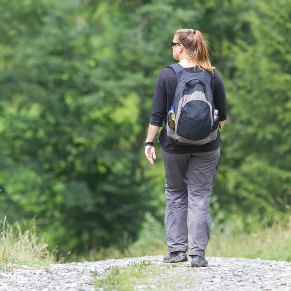 Hiker, young woman with backpack — Stock Photo, Image