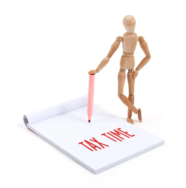 Wooden mannequin writing - Tax time — Stock Photo, Image