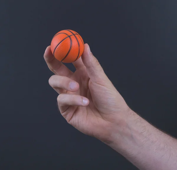 Изолированная рука с мини-баскетбольным мячом — стоковое фото