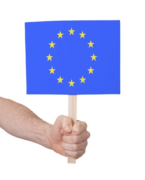 Hand met kleine kaartje - vlag van de Europese Unie — Stockfoto